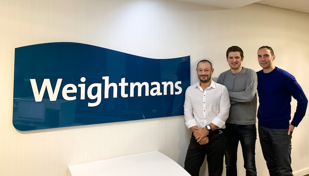Stuart Whittle of Weightmans poses with the founders of Frontier Labs
