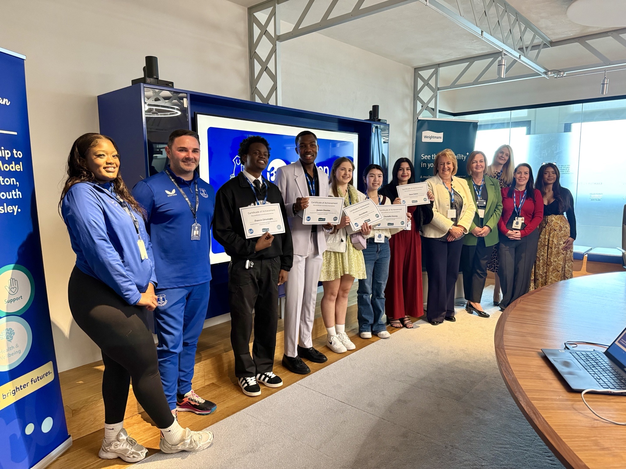 Members of the Everton in the Community programme show off their certificates