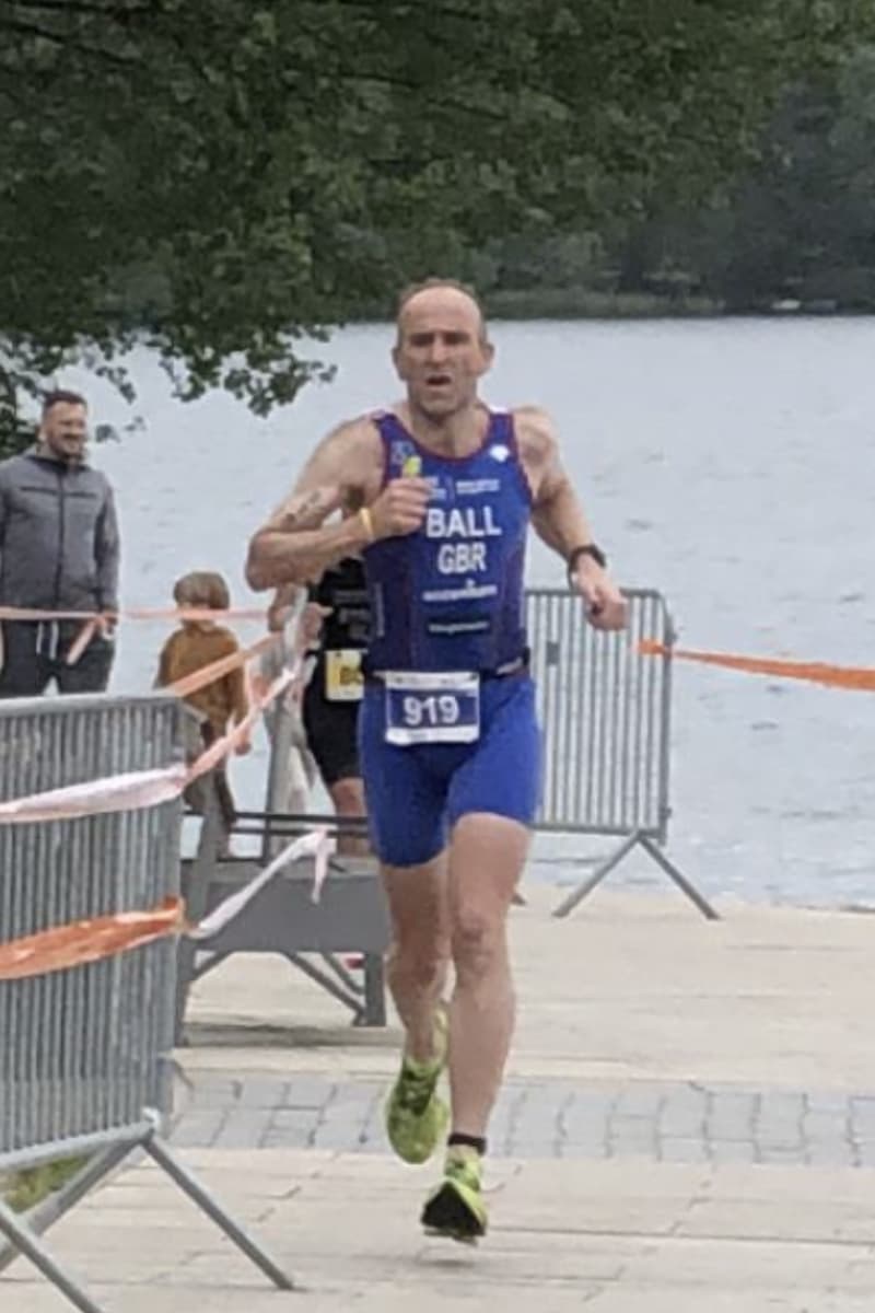 An action shot of Chris Ball competing in the triathalon
