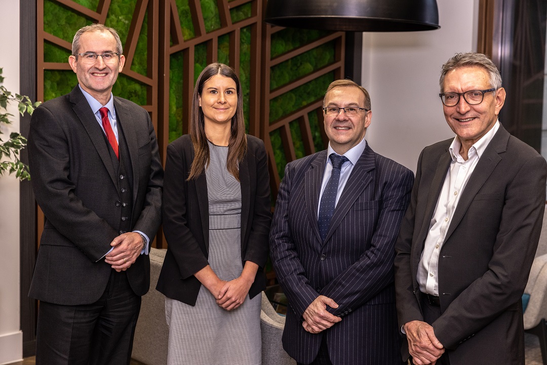 The four new recruits standing in our London office